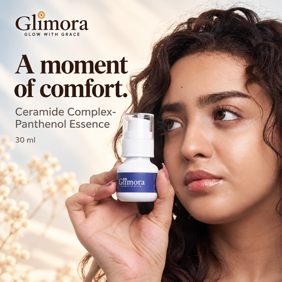 Model holding GLIMORA Ceramide Complex-Panthenol Essence beside her face against an ivory and mist-blue background.