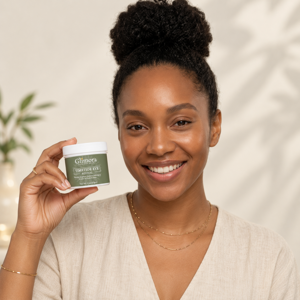 Smiling model holding a GLIMORA TimeTide Eye Revival jar beside her face.